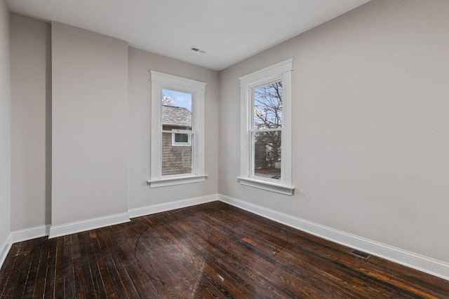 spare room featuring dark hardwood / wood-style flooring