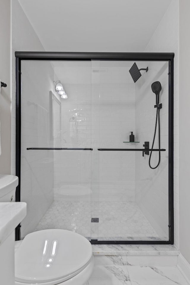 bathroom with a shower with door