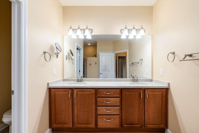 bathroom featuring vanity, toilet, and walk in shower