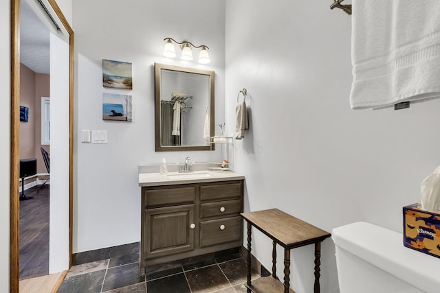 bathroom featuring vanity, wood-type flooring, and toilet