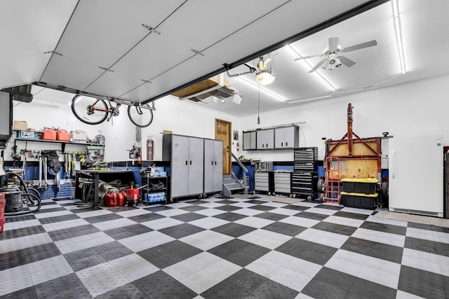 garage with a workshop area and ceiling fan