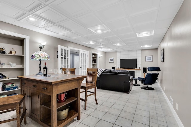 tiled dining space featuring built in shelves and french doors