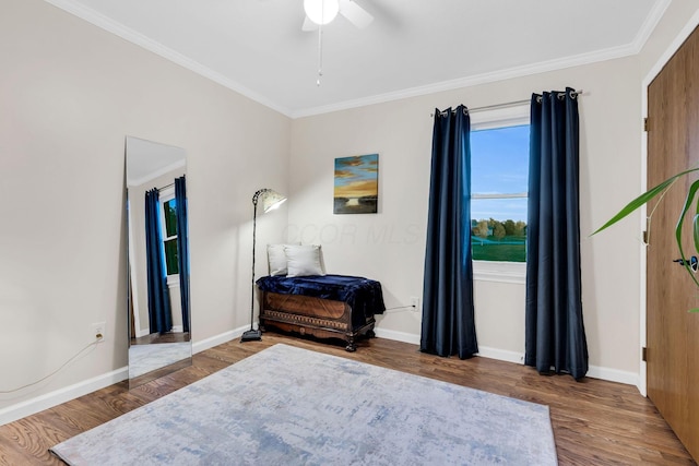 bedroom with hardwood / wood-style floors, ceiling fan, and ornamental molding