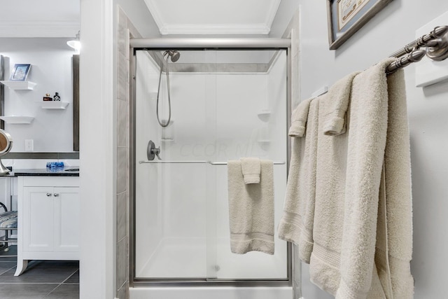 bathroom featuring tile patterned flooring, vanity, walk in shower, and ornamental molding