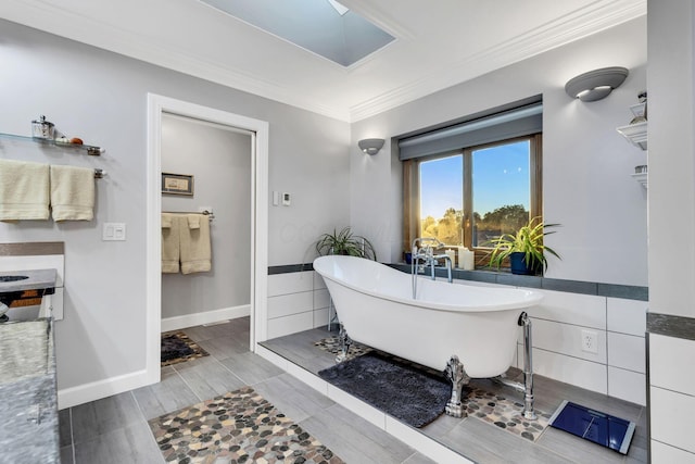 bathroom with crown molding and a bath