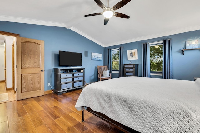 bedroom featuring ceiling fan, wood-type flooring, ornamental molding, and lofted ceiling