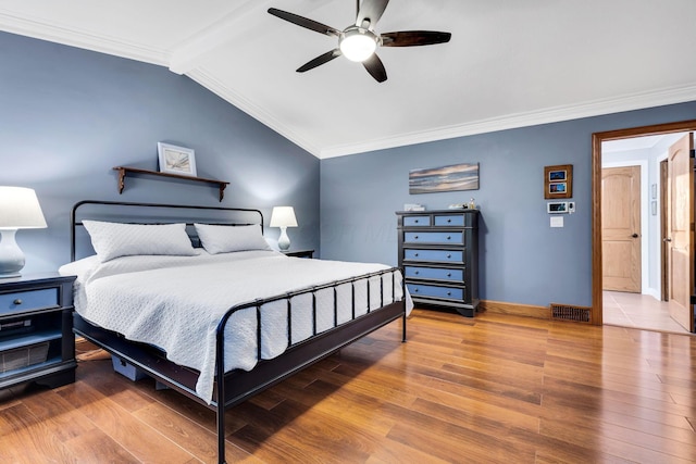 bedroom featuring vaulted ceiling with beams, ceiling fan, hardwood / wood-style floors, and crown molding