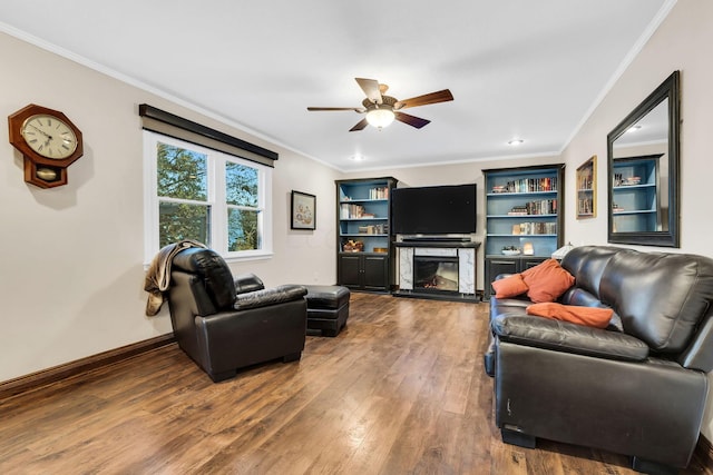 living room featuring hardwood / wood-style floors, ceiling fan, and crown molding