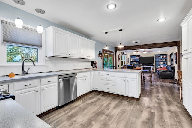 kitchen featuring white cabinetry, dishwasher, kitchen peninsula, pendant lighting, and hardwood / wood-style flooring