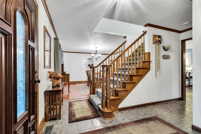 stairs featuring tile patterned flooring, ornamental molding, a textured ceiling, and a notable chandelier