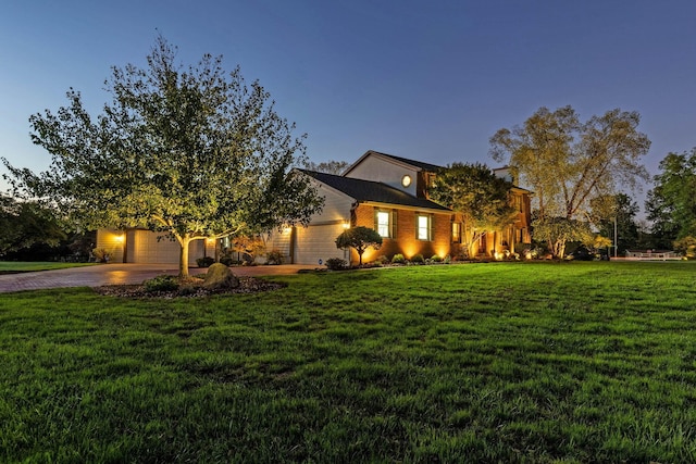 view of front facade with a garage and a yard