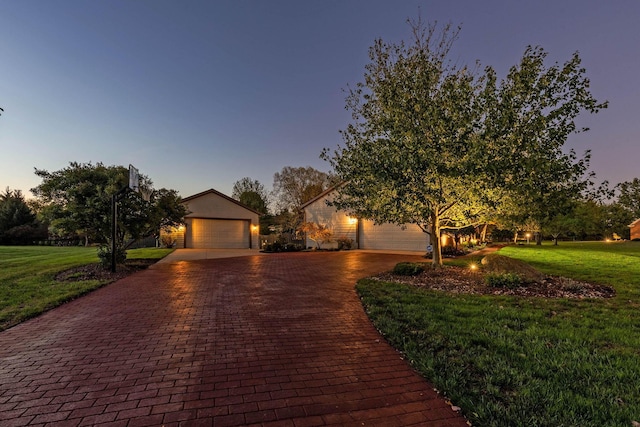 view of front of house featuring a yard and a garage