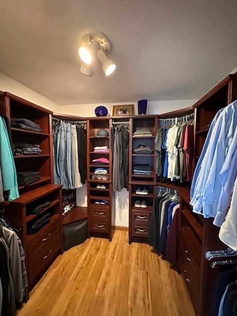 spacious closet featuring light hardwood / wood-style flooring