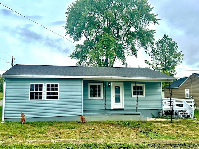 view of front of home with a porch and a front yard