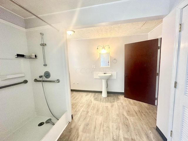 bathroom featuring hardwood / wood-style floors and a shower