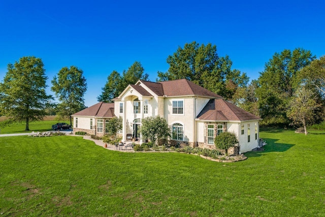 rear view of property featuring a lawn