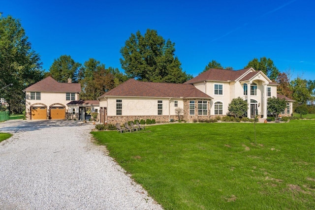 view of front of property with a front lawn and a garage