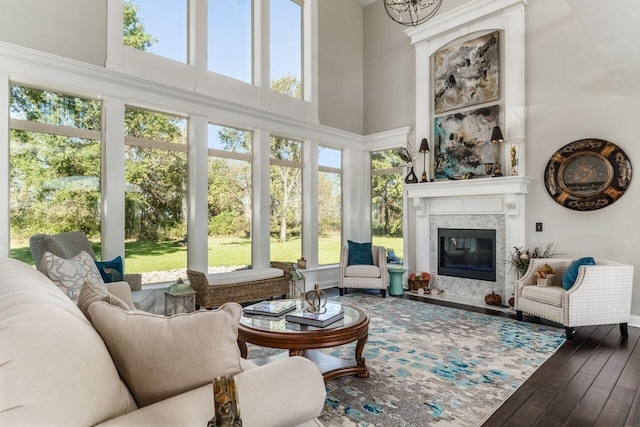 sunroom featuring a high end fireplace