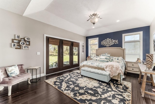 bedroom featuring access to exterior, a textured ceiling, lofted ceiling, and dark wood-type flooring