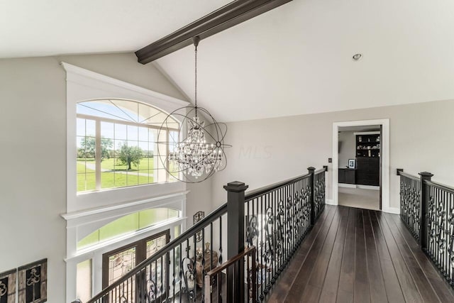 corridor with lofted ceiling with beams, an inviting chandelier, and dark wood-type flooring