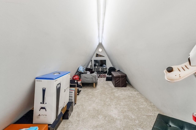 playroom featuring light carpet and vaulted ceiling