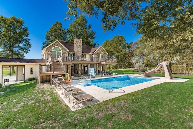 view of pool featuring a deck, a lawn, a patio area, and a water slide