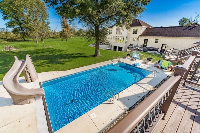 view of pool with a yard, a patio area, and a water slide