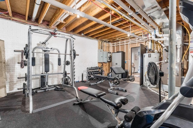 exercise area with electric panel and brick wall