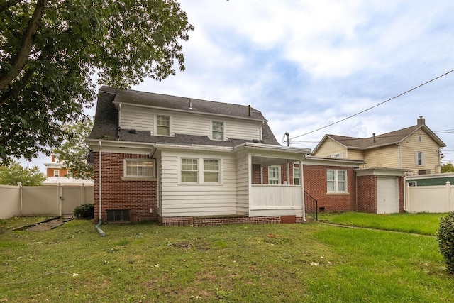 rear view of property featuring a yard and a garage