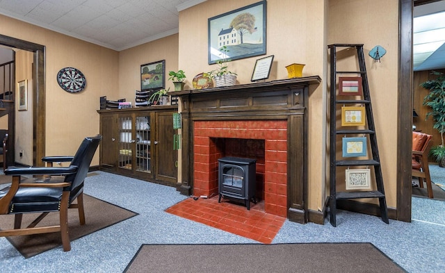 carpeted home office with a wood stove and ornamental molding