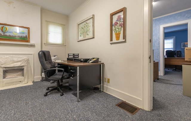 carpeted home office featuring crown molding