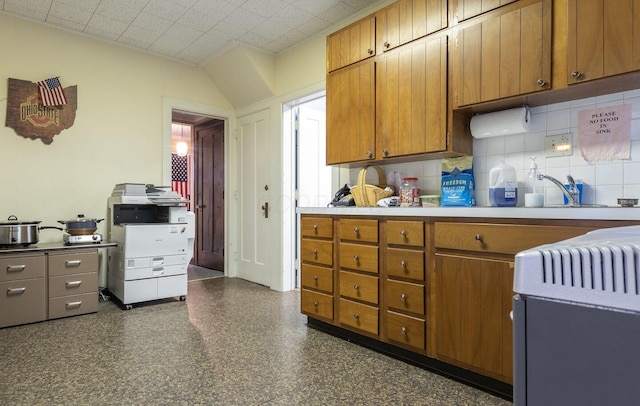 kitchen with backsplash, sink, and range