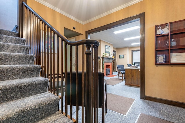 staircase with a fireplace and crown molding