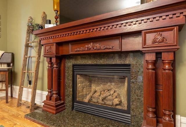 interior details featuring hardwood / wood-style floors and a high end fireplace