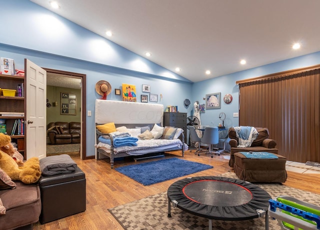 living room featuring light hardwood / wood-style floors and high vaulted ceiling