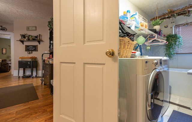 laundry area featuring hardwood / wood-style floors and a textured ceiling