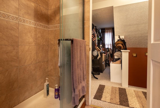 bathroom with a textured ceiling and walk in shower