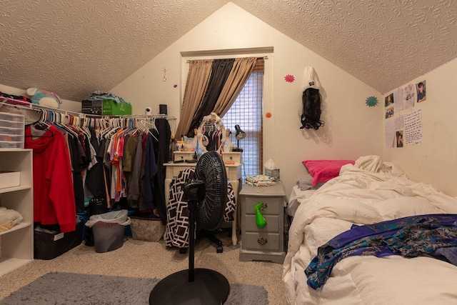 bedroom featuring carpet, a textured ceiling, and vaulted ceiling