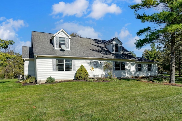 cape cod house featuring a front yard