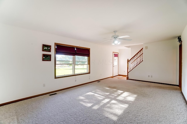 carpeted spare room with ceiling fan