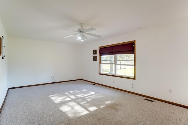 carpeted empty room featuring ceiling fan