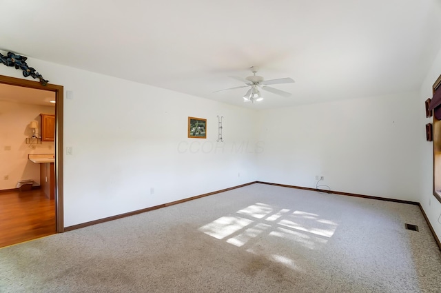 spare room with carpet flooring and ceiling fan