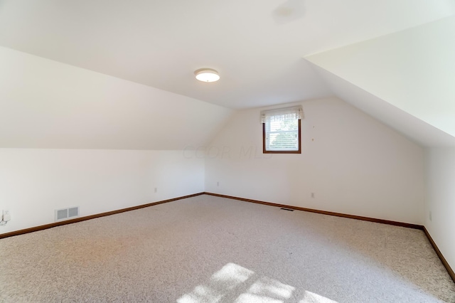 bonus room featuring carpet floors and vaulted ceiling