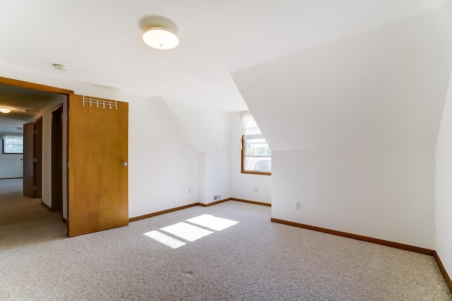 bonus room featuring carpet floors and vaulted ceiling