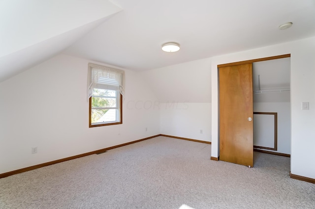 bonus room featuring light colored carpet and lofted ceiling