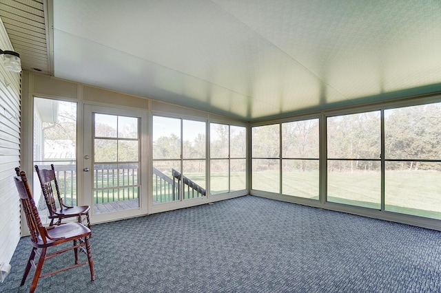 unfurnished sunroom featuring vaulted ceiling