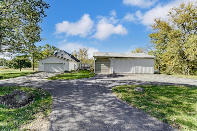 ranch-style home with an outbuilding and a front lawn