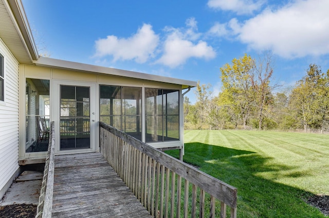 wooden terrace featuring a sunroom and a yard