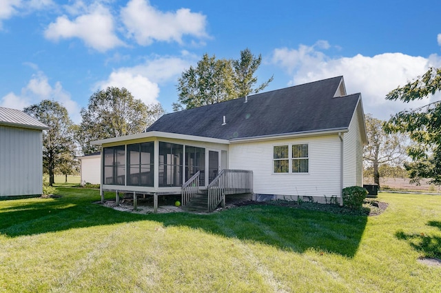 rear view of house with a lawn and a sunroom