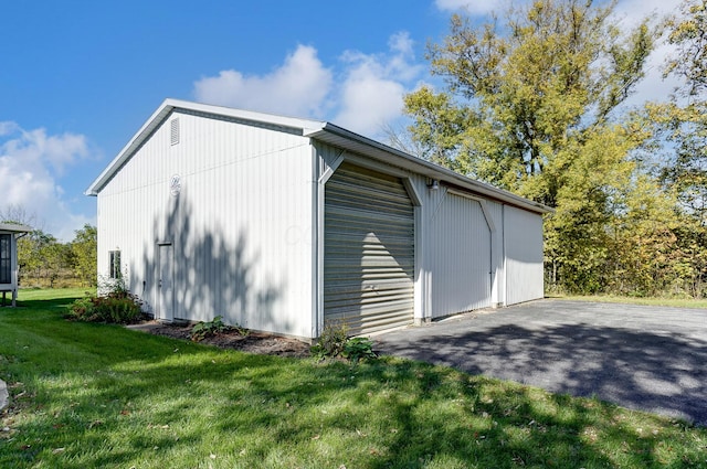 garage featuring a lawn